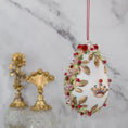 Load image into Gallery viewer, Golden Crown Easter Egg Beaded Ornament embellished with flowers, gold leaves, floral trim, and crystal beads. Side view. (White).