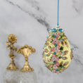 Load image into Gallery viewer, Golden Crown Easter Egg Beaded Ornament embellished with flowers, gold leaves, floral trim, and crystal beads. Side. (Light Yellow).