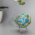 Load image into Gallery viewer, Golden Crown Easter Egg Beaded Ornament embellished with flowers, gold leaves, floral trim, and crystal beads. Bottom detail. (Sky Blue).