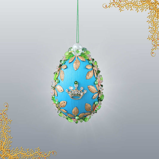 Golden Crown Easter Egg Beaded Ornament embellished with flowers, gold leaves, floral trim, and crystal beads. Front. (Sky Blue).