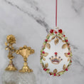 Load image into Gallery viewer, Golden Crown Easter Egg Beaded Ornament embellished with flowers, gold leaves, floral trim, and crystal beads. Front. (White).