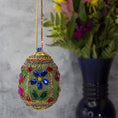 Load image into Gallery viewer, Handmade Easter Egg Beaded Ornament embellished with flowers, leaves, gold floral trim, and crystal beads. Side. (Olive).
