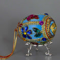 Load image into Gallery viewer, Handmade Easter Egg Beaded Ornament embellished with flowers, leaves, gold floral trim, and crystal beads. Bottom detail. (Sky Blue).