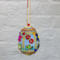 Load image into Gallery viewer, Handmade Easter Egg Beaded Ornament embellished with flowers, leaves, gold floral trim, and crystal beads. Side. (Sky Blue).