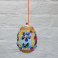 Load image into Gallery viewer, Handmade Easter Egg Beaded Ornament embellished with flowers, leaves, gold floral trim, and crystal beads. Side. (Sky Blue).