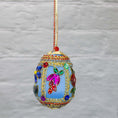Load image into Gallery viewer, Handmade Easter Egg Beaded Ornament embellished with flowers, leaves, gold floral trim, and crystal beads. Side. (Sky Blue).