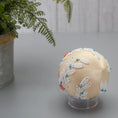 Load image into Gallery viewer, Christmas or Easter Beaded Ornament Ball embellished with flowers, trim, and beads. Handmade. Bottom detail. (Papaya Whip).