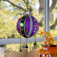Load image into Gallery viewer, Decorative purple ornament with colorful embellishments hanging outdoors.