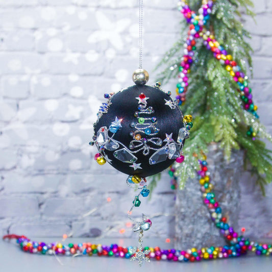 Jingle Bells Satin Ornament -Handmade Black Christmas Beaded Decoration, featuring large glass beads, sparkling silver trim, sequins, and alloy snowflakes, set against a small evergreen tree.