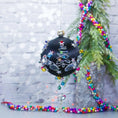 Load image into Gallery viewer, Jingle Bells Satin Ornament -Handmade Black Christmas Beaded Decoration, featuring large glass beads, sparkling silver trim, sequins, and alloy snowflakes, set against a small evergreen tree.