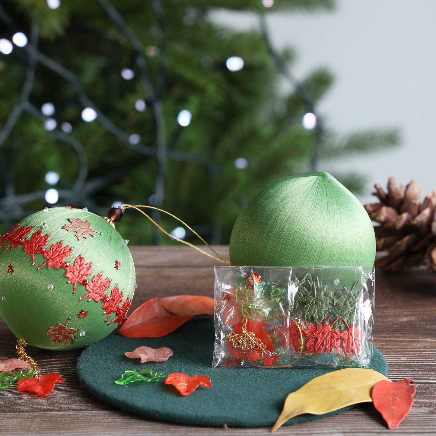 Green Christmas ornament with decorative elements on a wooden surface. (Olive)