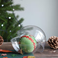 Load image into Gallery viewer, Green satin ball with a kit in a clear plastic round container on a wooden surface with decorative elements and a blurred Christmas tree in the background. (Olive)