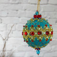Load image into Gallery viewer, Scheherazade Handmade Satin Ornament - Teal colored Christmas push pin decoration, featuring red rhinestones, red bicone beads, sequins, and metallic cord, perfect for holiday crafting, front view. (Light Sea Green)