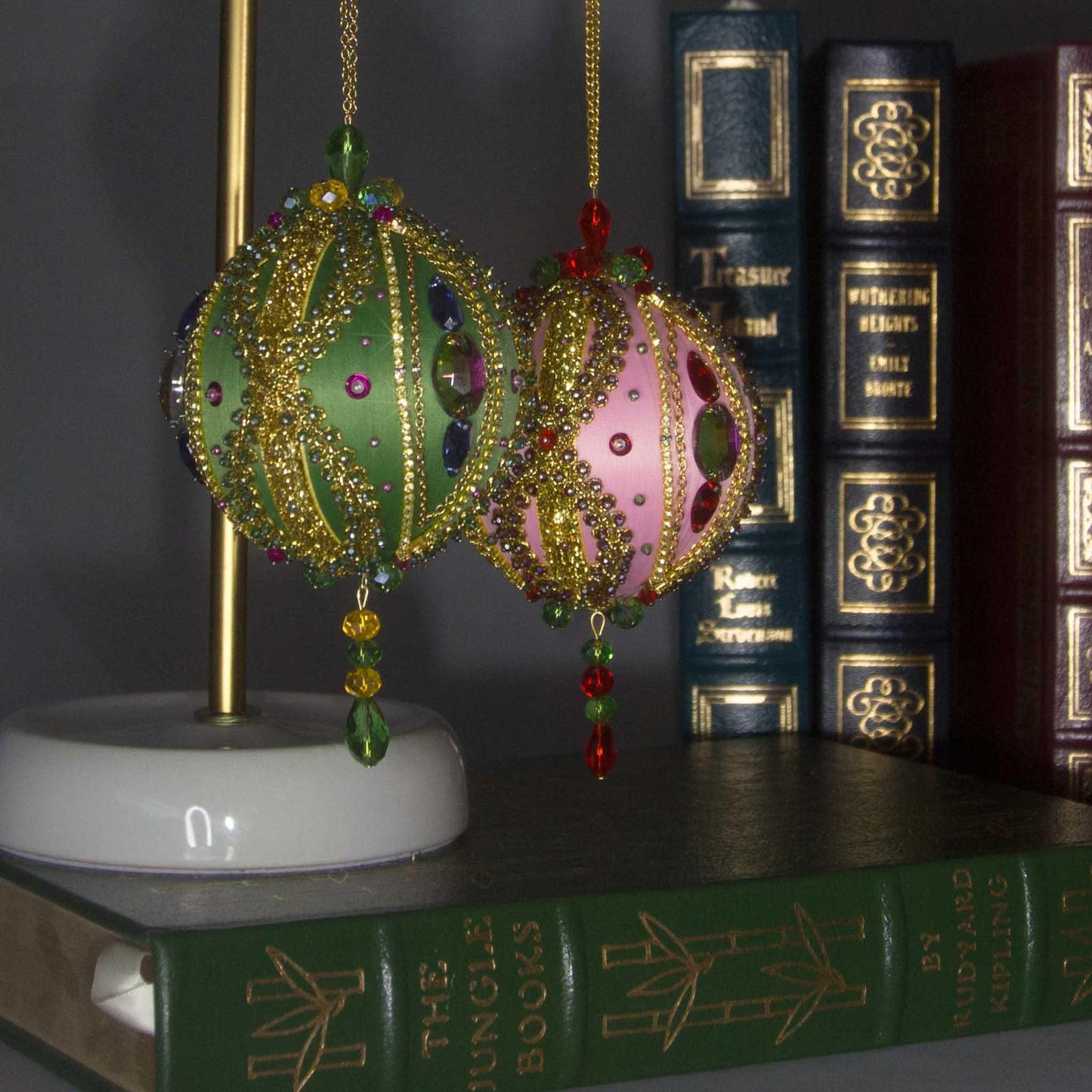 Collection of handmade Beaded Christmas Ornaments Uliger embellished with gold trim, color-shifting rhinestones, and sequins.