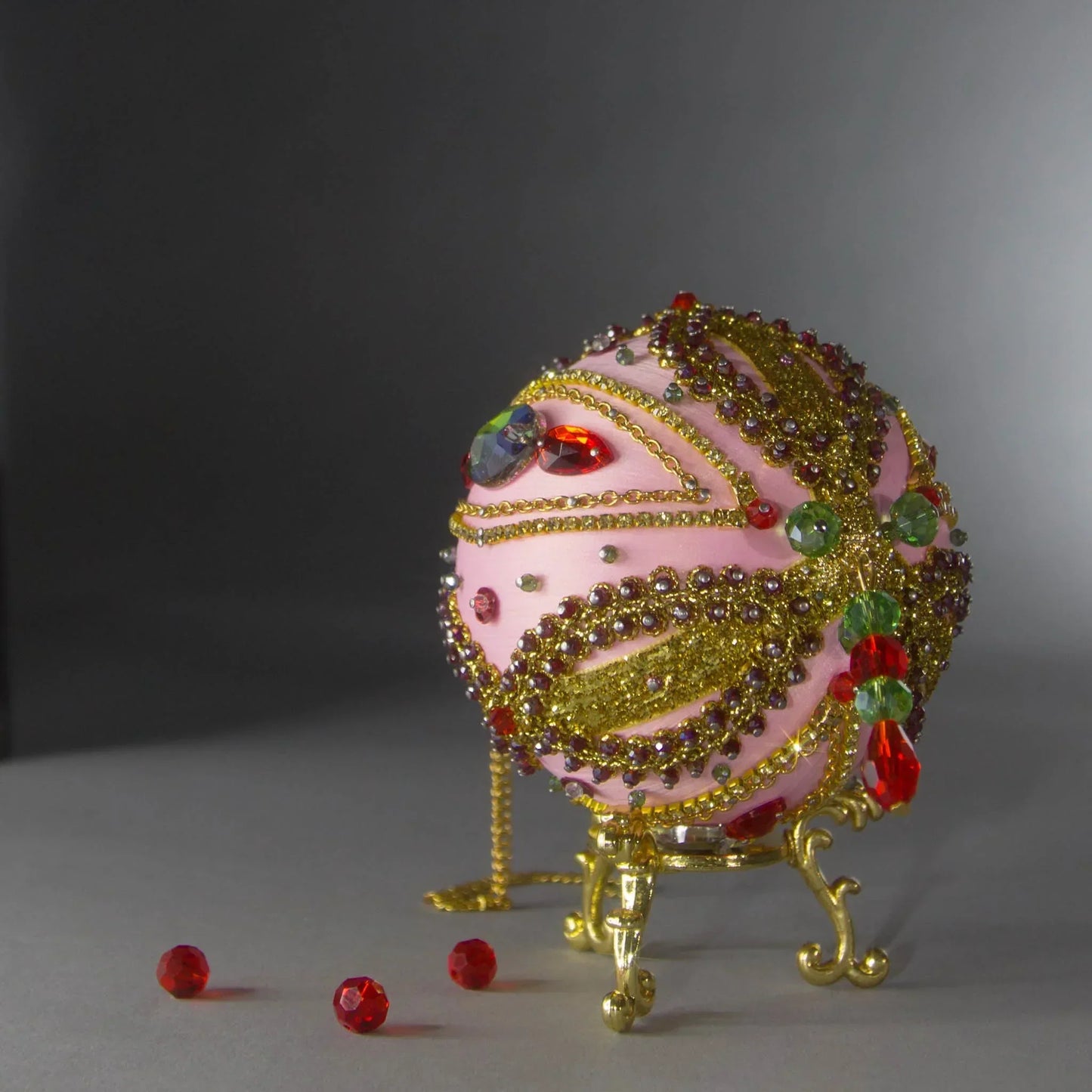 Christmas Beaded Ornament Kit Ball embellished with glass rhinestones, gold braided trim, and crystal beads. Bottom detail. (Light Pink).