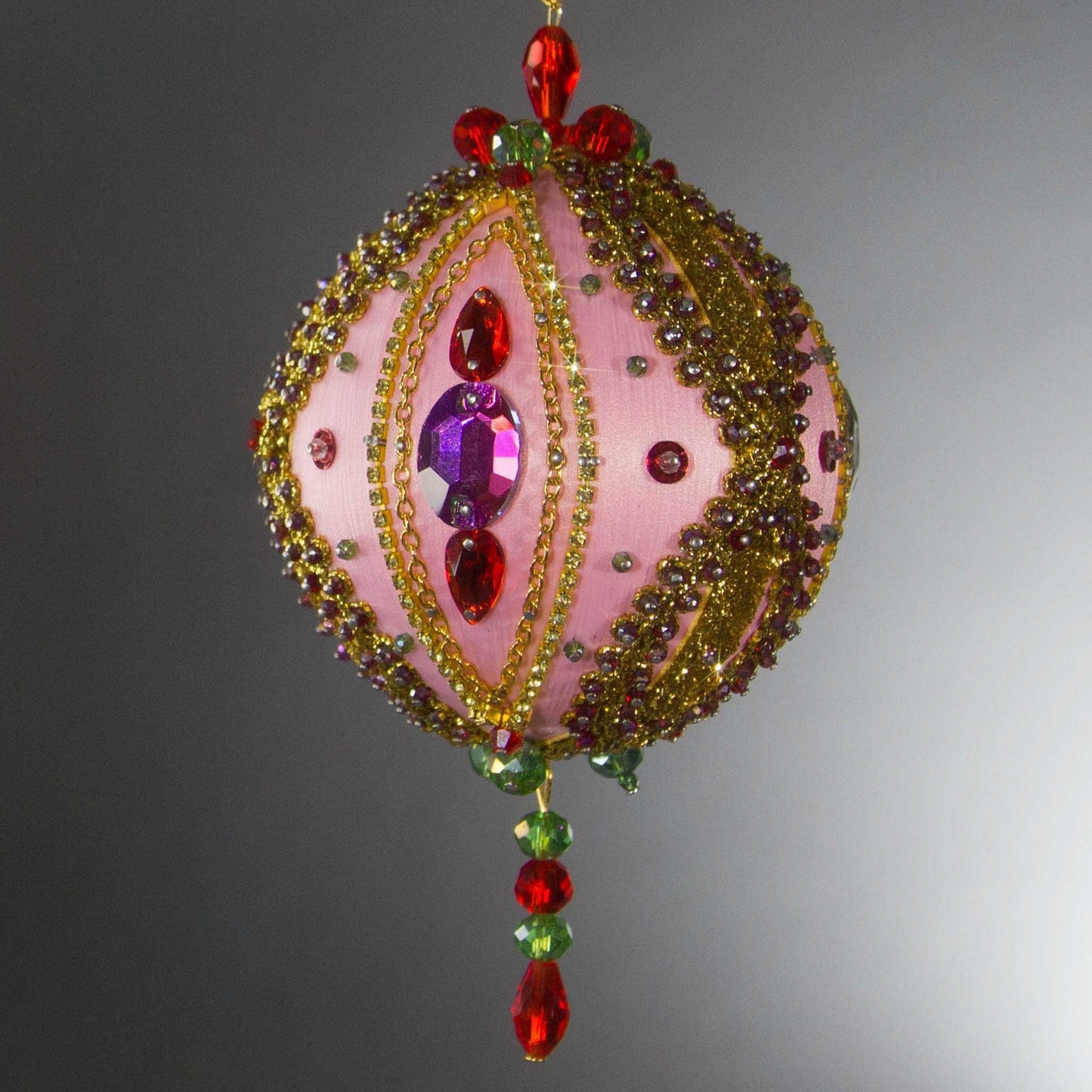 Christmas Beaded Ornament Kit Ball embellished with glass rhinestones, gold braided trim, and crystal beads. Front. (Light Pink).