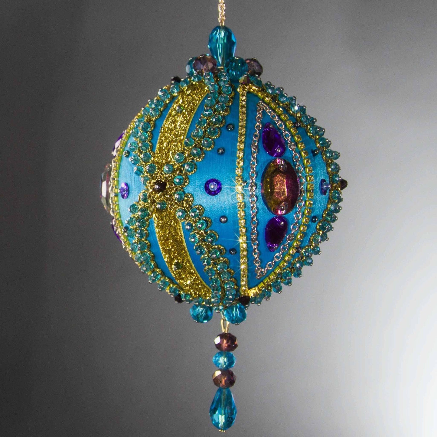 Christmas Beaded Ornament Kit Ball embellished with glass rhinestones, gold braided trim, and crystal beads. Side view. (Sky Blue).