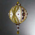 Load image into Gallery viewer, Handmade Satin Ornament by Whim5seasons embellished with glass rhinestones, gold braided trim, and crystal beads. Side view. (White).