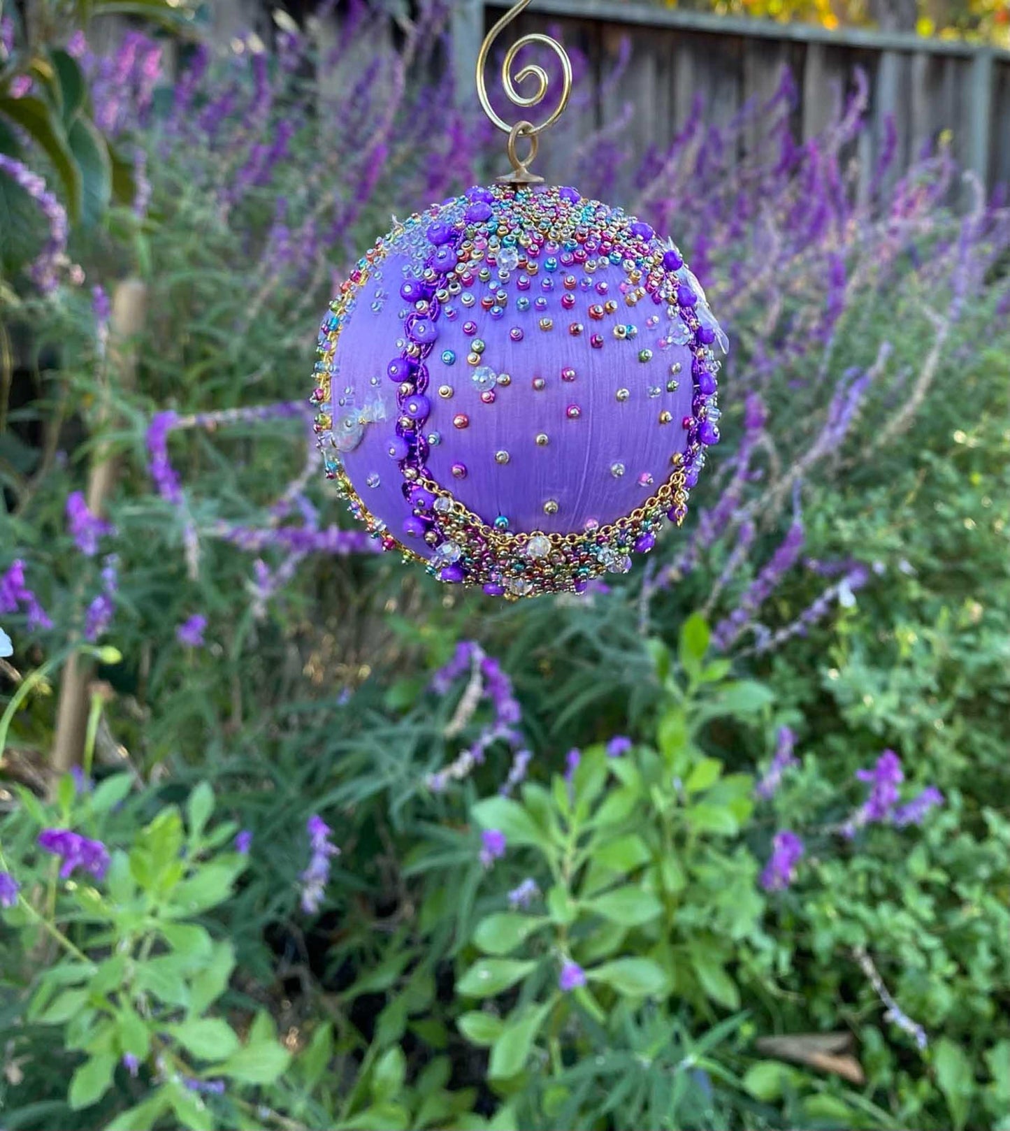 A close-up of the top of Handmade Christmas Ornament Candy by Whim5seasons - Miyuki seed beads, metallic cord hanger. (Medium Purple)