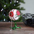 Load image into Gallery viewer, Decorative ornament with red flowers on a green stem against a blurred Christmas tree background. (White)