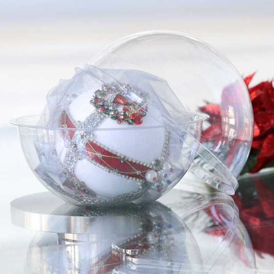 Handmade satin beaded white Christmas ornament embellished with beads and trims in front of gray background and holiday greenery in a clear plastic container by Whim5seasons.