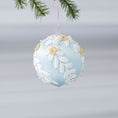 Load image into Gallery viewer, Handmade Mid-Century Style Beaded Christmas ornament - a satin push pin core as a base, embellished with white lace trim, yellow embroidered flowers, and pink and clear beads, hanging on a pink string loop (Light Blue)