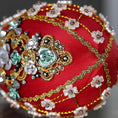 Load image into Gallery viewer, Close up of a handmade Easter Egg Push Pin Ornament embellished with crystals, beads, and metallic trim on a dark gray background. (Dark Red)