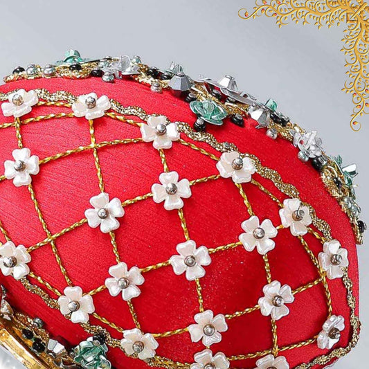 Close up of a handmade Easter Egg Push Pin Ornament embellished with crystals, beads, and metallic trim on a dark gray background by Whim5seasons.