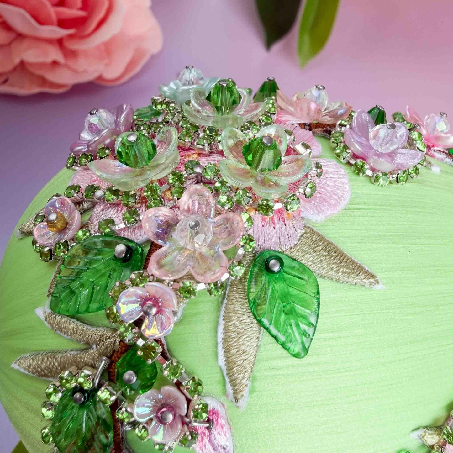 Detail of a handmade large Easter egg push pin ornament showing small beads and flower charms pinned by hand to a foam core using dressmaker pins by Whim5seasons.