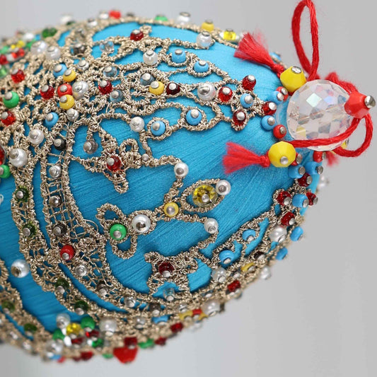 A close-up of a Handmade Easter Beaded Ornament from Whim5seasons meticulously crafted using high quality seed beads and tiny imitation pearls by pinning them with dressmaker pins.