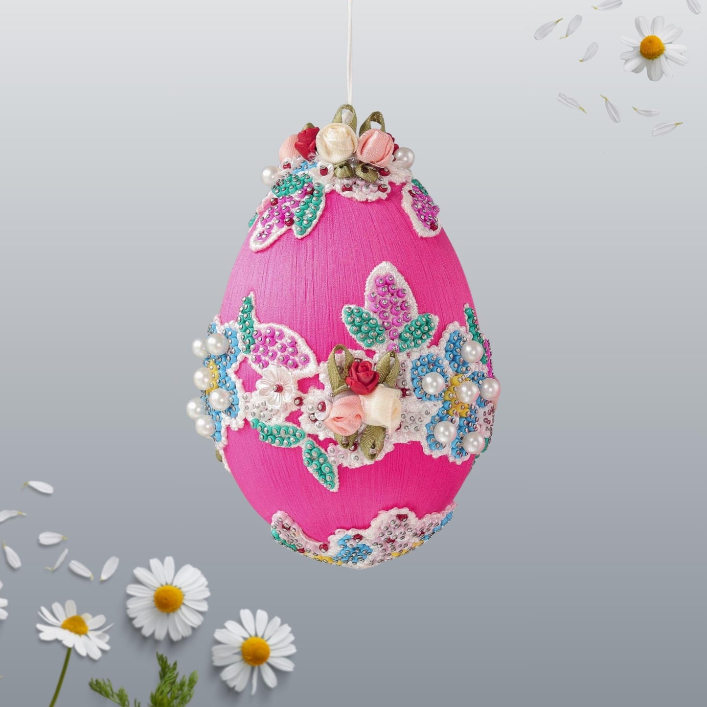 Festive pink handmade beaded Push Pin Easter egg ornament handmade using seed beads and hundreds of dressmaker pins with floral lace on a gray background by Whim5seasons.