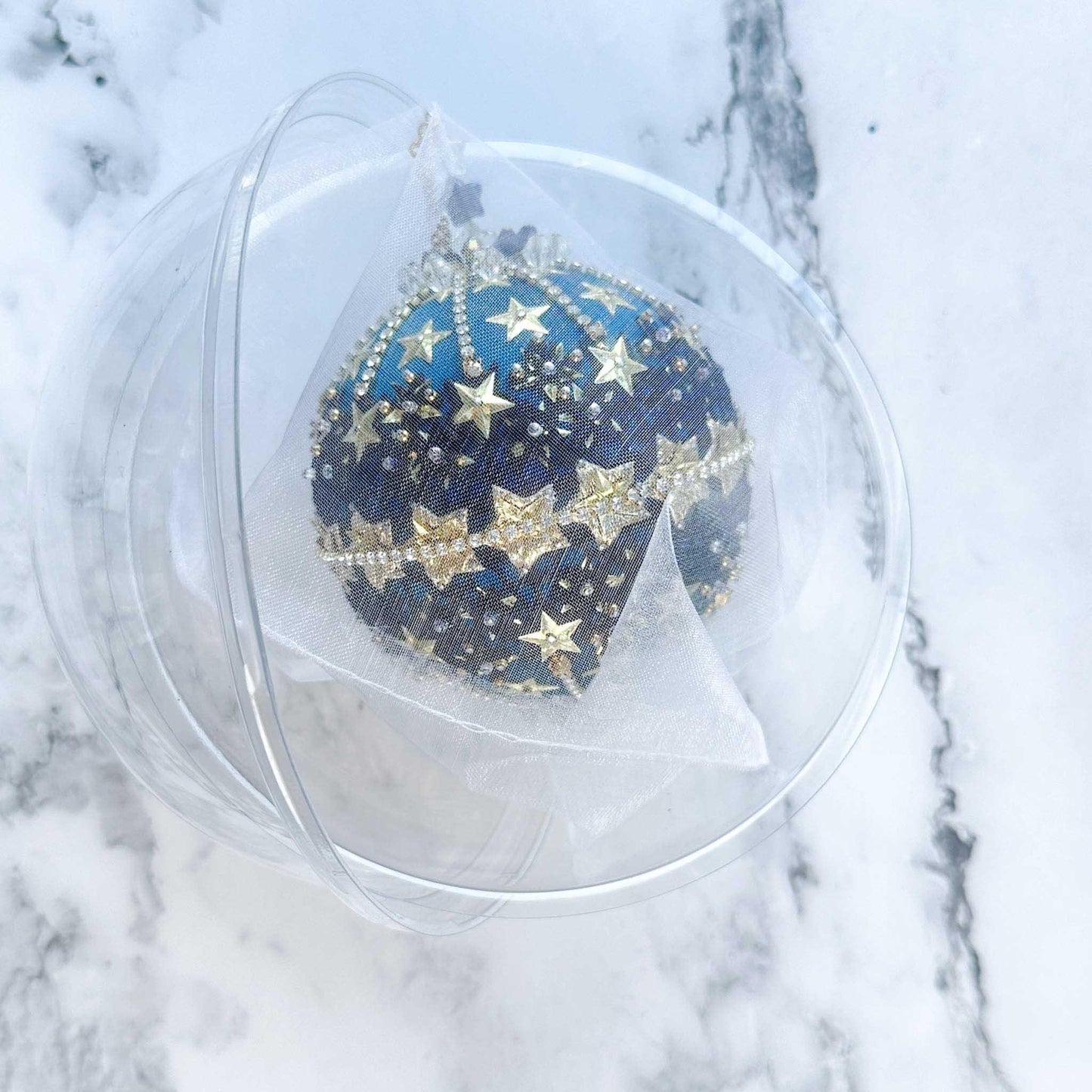 Handmade New Year Star Ornament from Whim5seasons in a clear round storage container wrapped in organza. (Dark Slate Blue)
