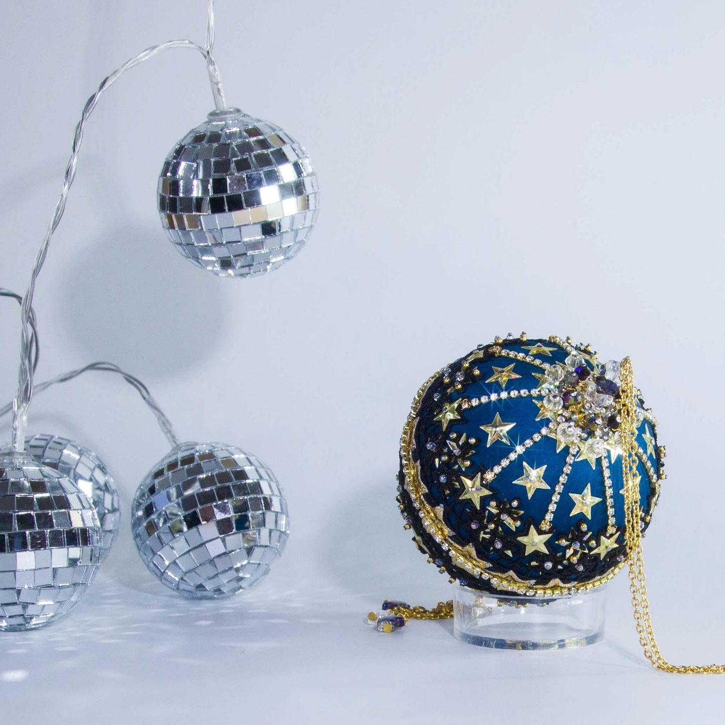 A close view of the bottom detail of New Year Star Ornament from Whim5seasons showcasing sparkling rhinestones, gold sequin stars, and crystal beads. (Dark Slate Blue)