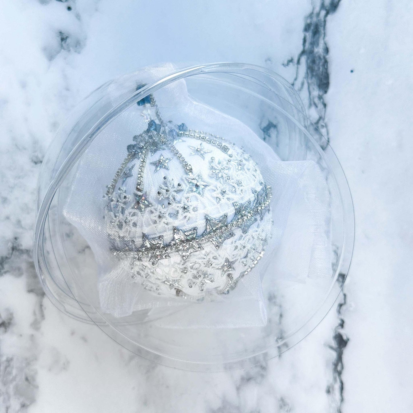 Handmade New Year Star Ornament from Whim5seasonswrapped in organza bag in a clear round storage container. (White)