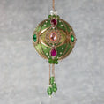 Load image into Gallery viewer, Side view of Phoenix Christmas Handmade Satin Ornament features large cameos with pink and green rhinestones, gold alloy accents, and gold chain. (Olive)