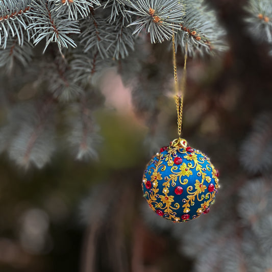 An enchanting handmade satin push pin ornament hanging outside on a light green pine branch from Whim5seasons.