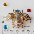 Load image into Gallery viewer, The back of a Bee brooch, approximately 2" by 2". Versatile embellishment for a garment, handbag, or a large ornament from Whim5seasons.