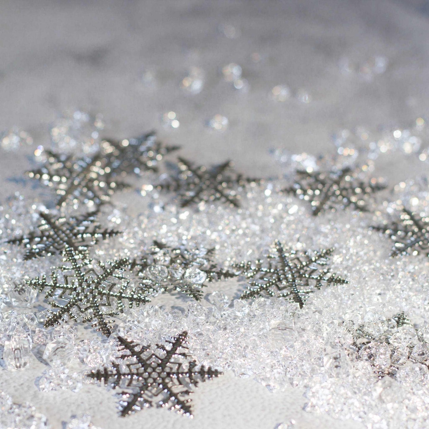 Christmas Craft Supplies: Close-up of six intricate silver snowflake filigree metal stampings - Whim5seasons.