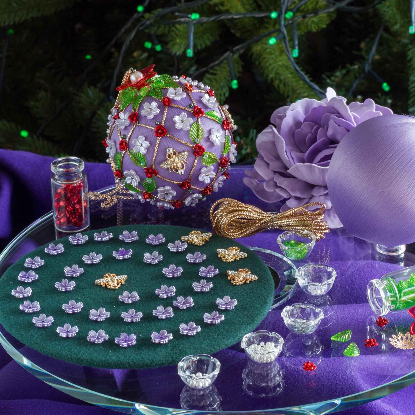 DIY Project featuring satin lavender colored ball with floral patterns on a table with craft materials. (Medium Purple).