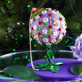 Load image into Gallery viewer, One-of-a-kind handmade Floral ornament on a green metal stand against a greenery background. (Medium Purple).