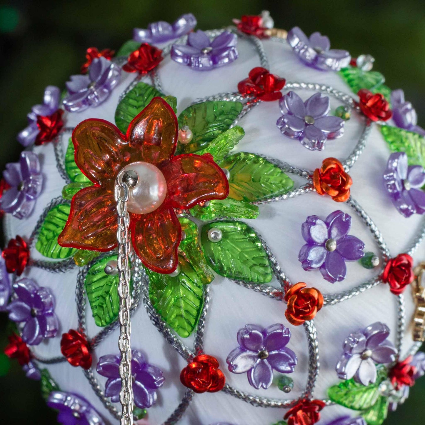 Close-up detail of Satin Handmade Ornament Trellis item with colorful flowers and a pearl on a white. (White).
