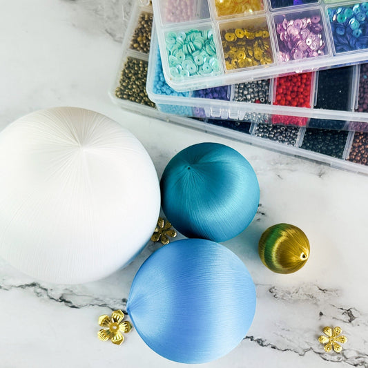 4 different sizes of satin balls and boxes with beads and sequins