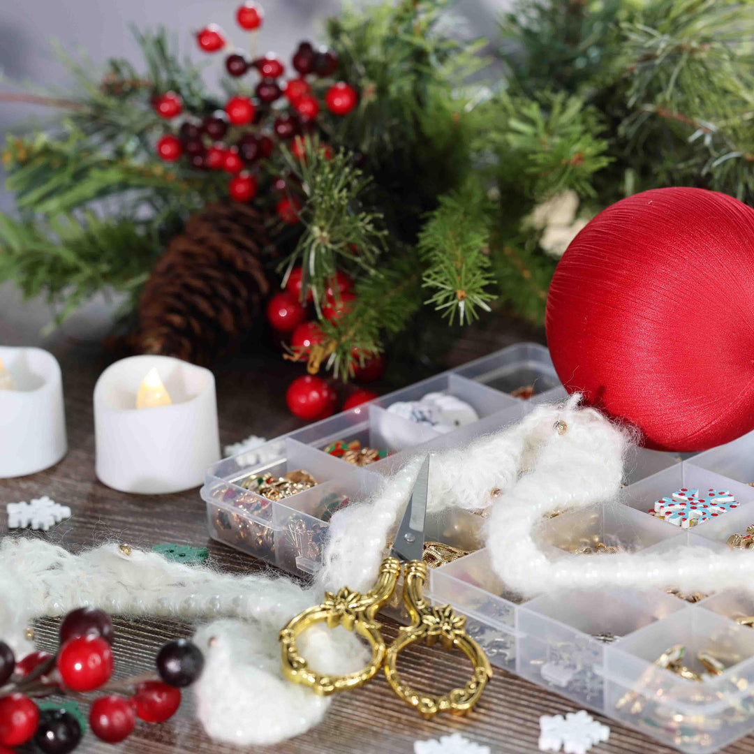 DIY crafting materials for Christmas decorations including red satin ornament, scissors, and white knit trim..