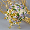 Load image into Gallery viewer, Vintage inspired charming Easter Egg Beaded Ornament embellished with flowers, leaves, gold floral trim, and crystal beads. Top detail. (Old Lace).
