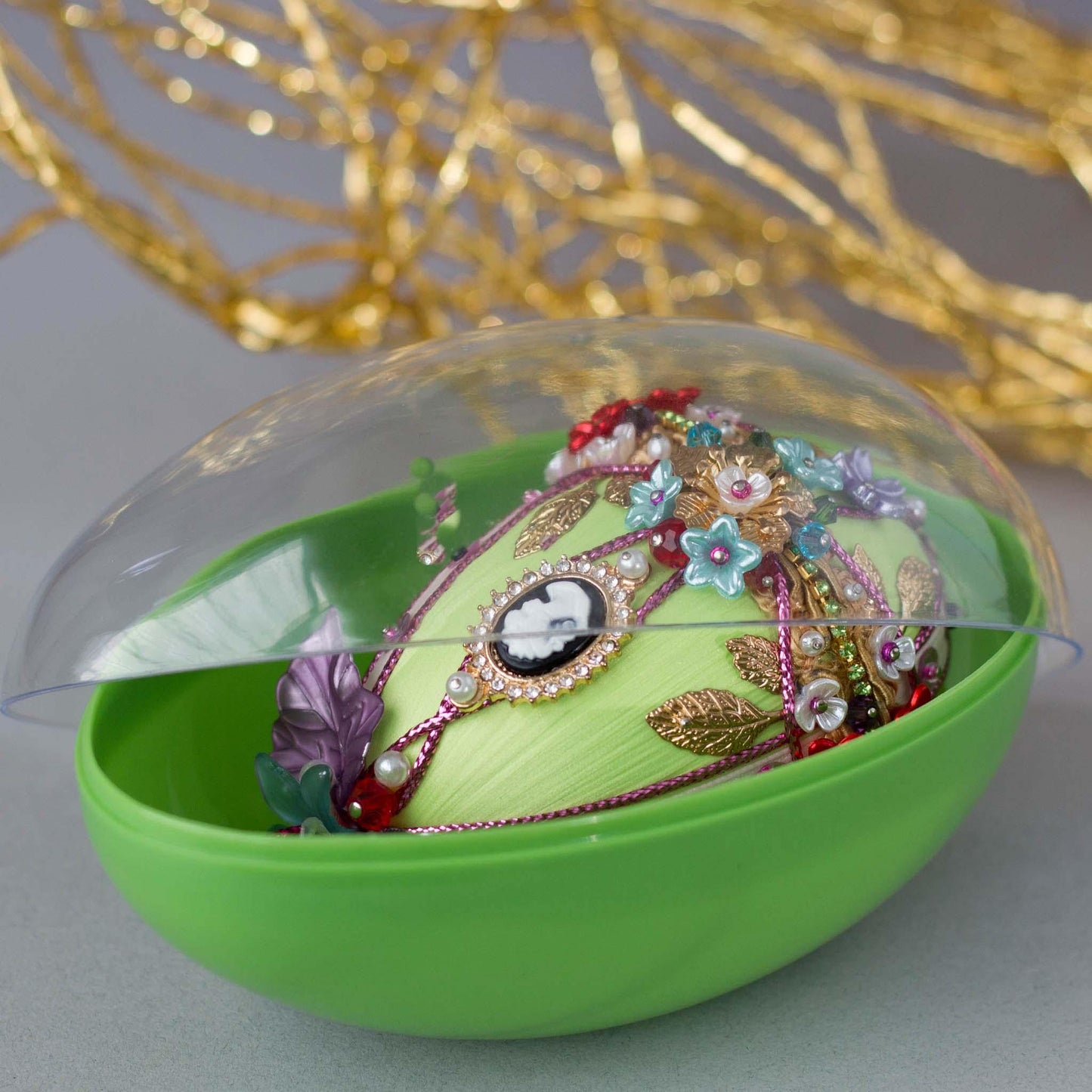 Anna Easter Egg Push Pin Ornament in a green storage egg-shaped container with a clear lid. (Lime).