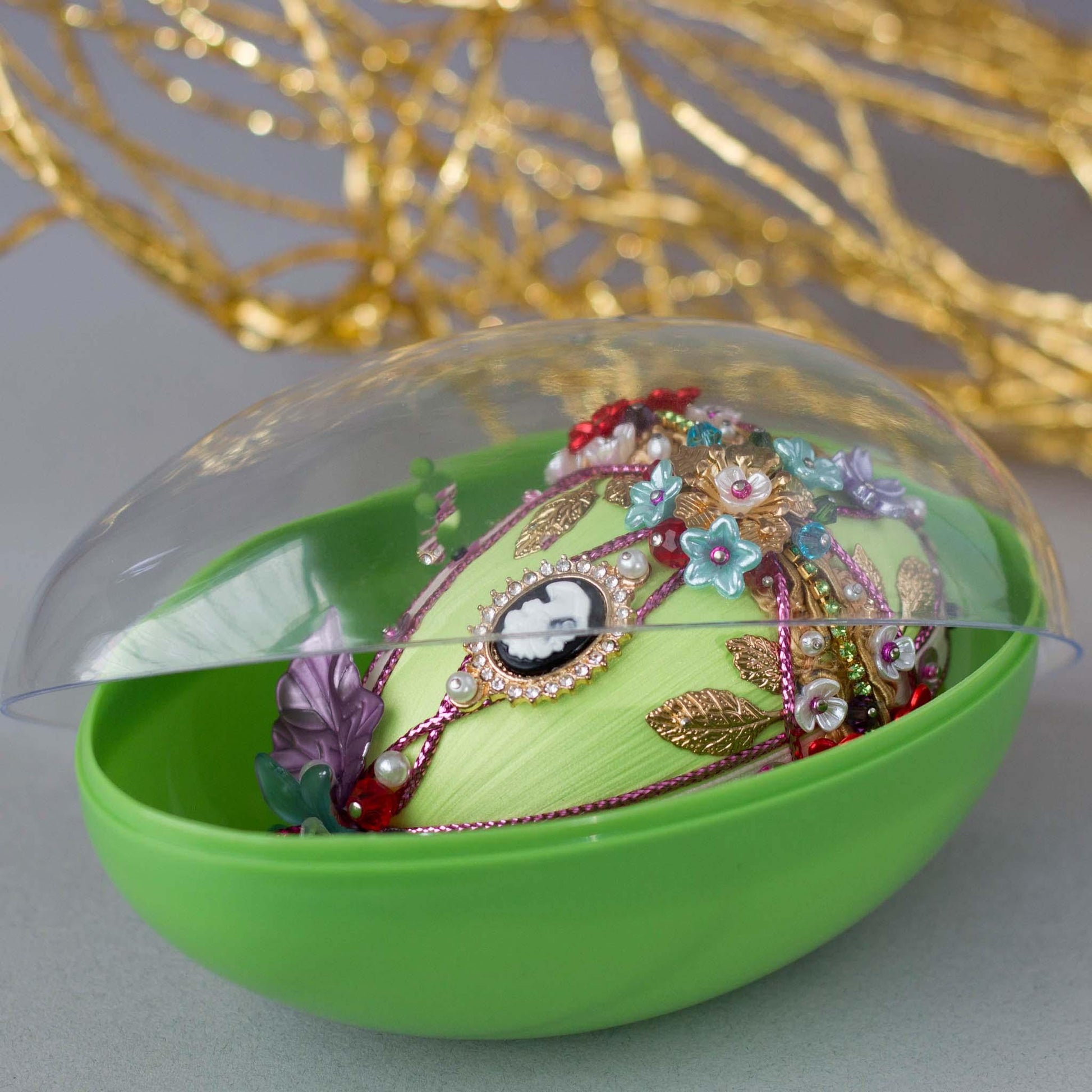 Anna Easter Egg Push Pin Ornament in a green storage egg-shaped container with a clear lid. (Lime).