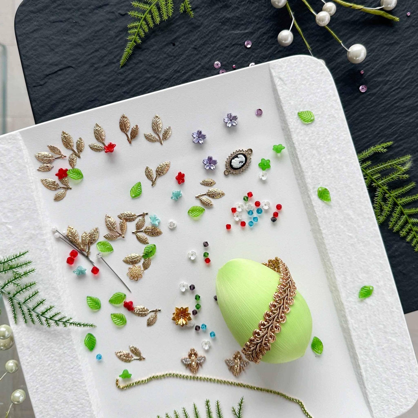 Materials to make Easter Egg Beaded Ornament Anna by pinning glass rhinestones chains, gold, and crystal beads to a satin ball. (Lime).