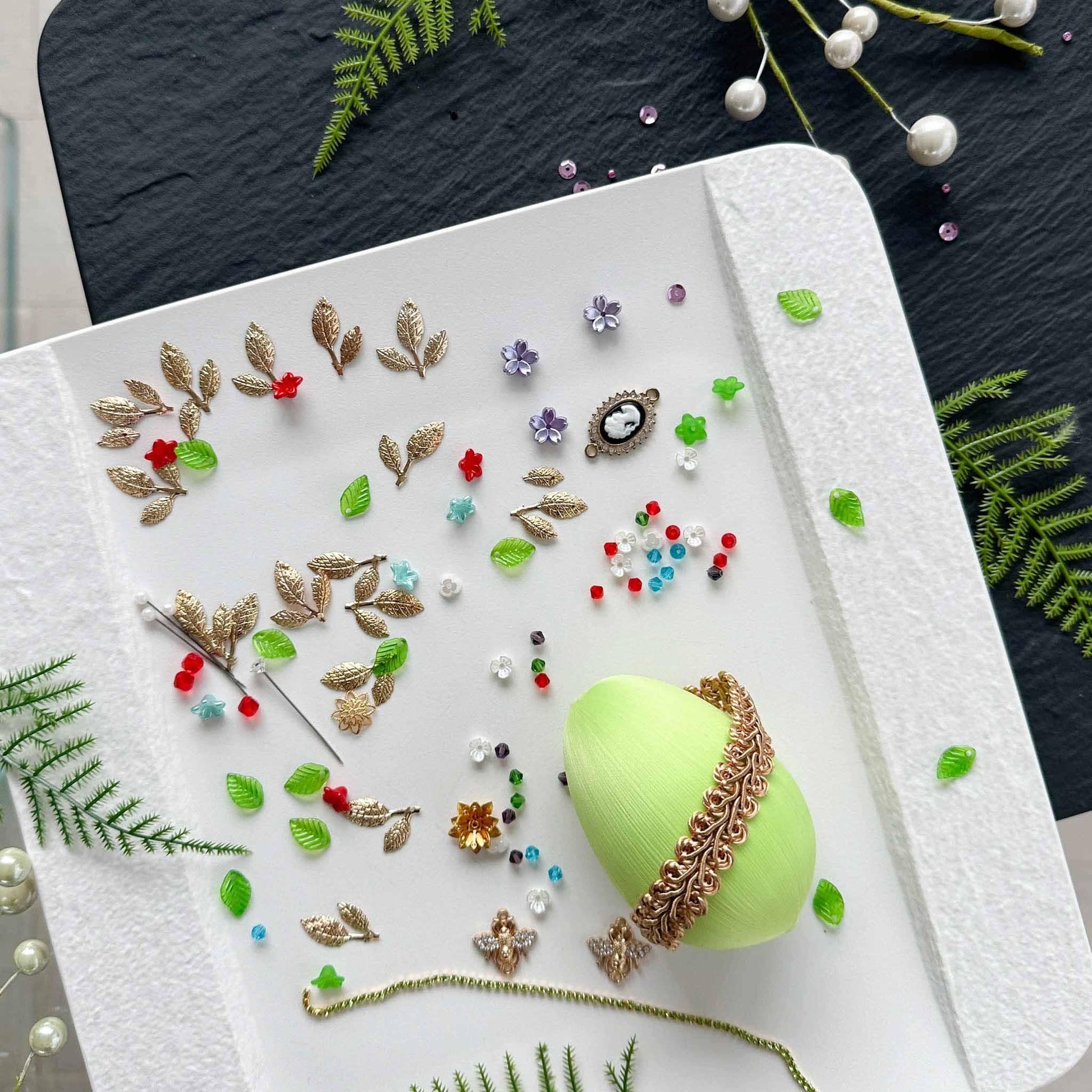 Materials to make Easter Egg Beaded Ornament Anna by pinning glass rhinestones chains, gold, and crystal beads to a satin ball. (Lime).