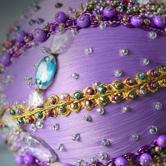 A close-up of the top of Handmade Christmas Ornament Candy by Whim5seasons - thousand of Miyuki seed beads, top crystal bead. (Medium Purple) 