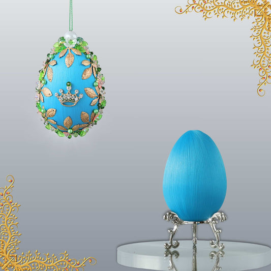 Golden Crown Easter Egg Beaded Ornament embellished with flowers, gold leaves, floral trim, and crystal beads. Side view. (Sky Blue).
